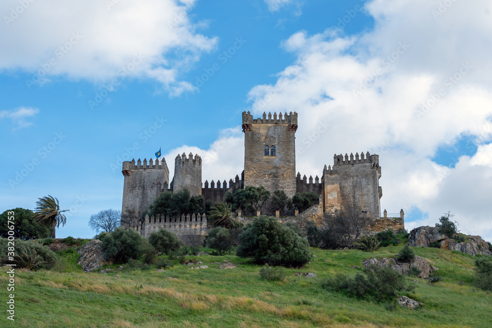 Imposing medieval castle of Almodovar del Rio on a hill and a beautiful blue sky and white clouds