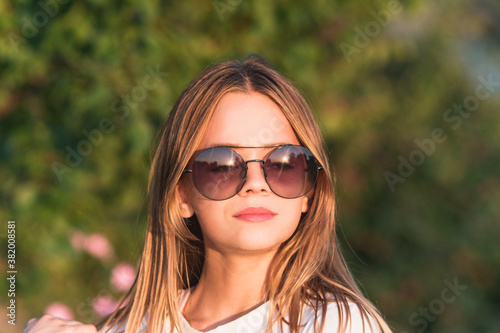 Young girl wearing glasses during evening sunset
