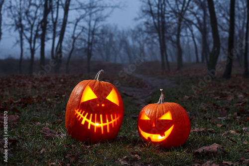 Halloween pumpkins burning in forest at night © kobeza