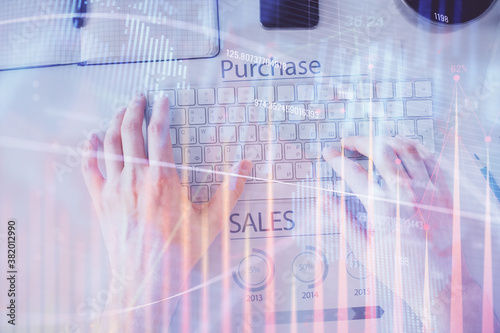 Double exposure of man's hands typing over laptop keyboard and forex chart hologram drawing. Top view. Financial markets concept.