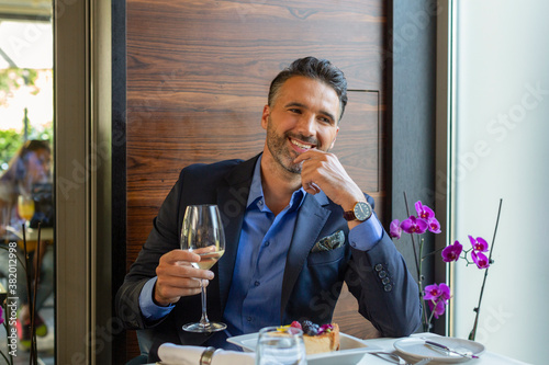 Photography Handsome man drinking white wine in the restaurant
