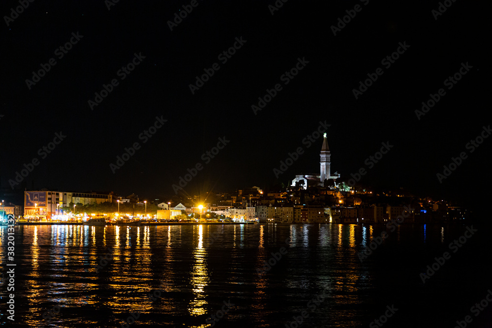 Picture of the illuminated historic part of Rovinj at night