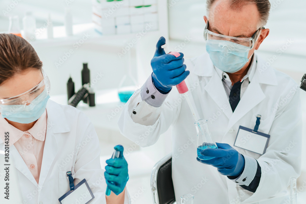 close up. researchers work with tests in the laboratory. close up. researchers work with tests in the laboratory.
