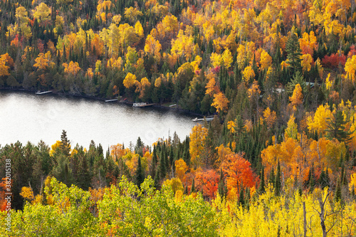 High angle view of lakeshore with docks in northern Minnesota and trees in bright autumn color