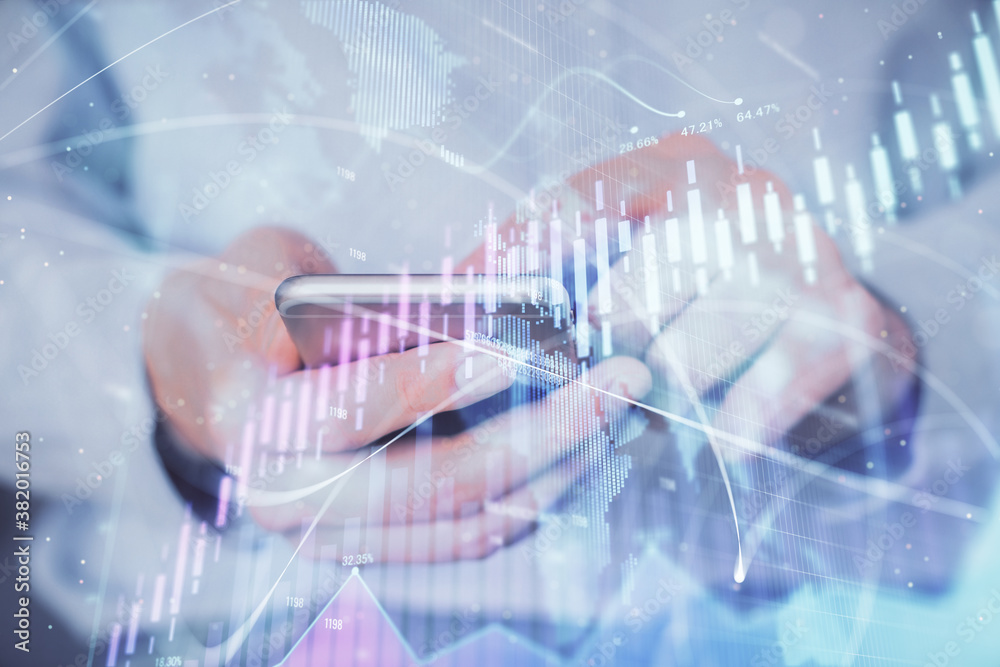 Double exposure of man's hands holding and using a digital device and forex graph drawing. Financial market concept. Double exposure of man's hands holding and using a digital device and forex graph drawing. Financial market concept.