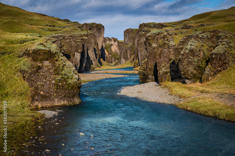 Beautiful Fjadrargljufur canyon with river and mossy rocks in Iceland