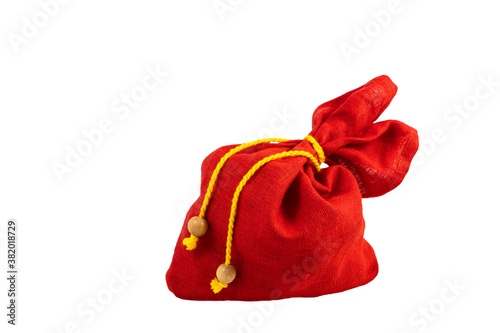 Gift sack of red color with yellow rope. Christmas presents bag isolated on white background.