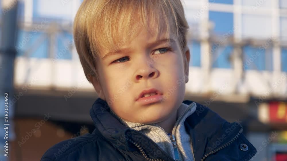 Portrait Serious Blond Child. Thoughtful Pensive Look. Cute Toddler Face Expression Emotion. Winter City Urban Background. 2x Slow motion 60 fps 4K Portrait Serious Blond Child. Thoughtful Pensive Look. Cute Toddler Face Expression Emotion. Winter City Urban Background. 2x Slow motion 60 fps 4K