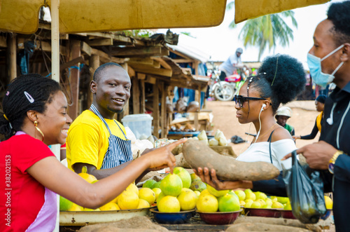 group of young africans making transaction happening in a market place. photo