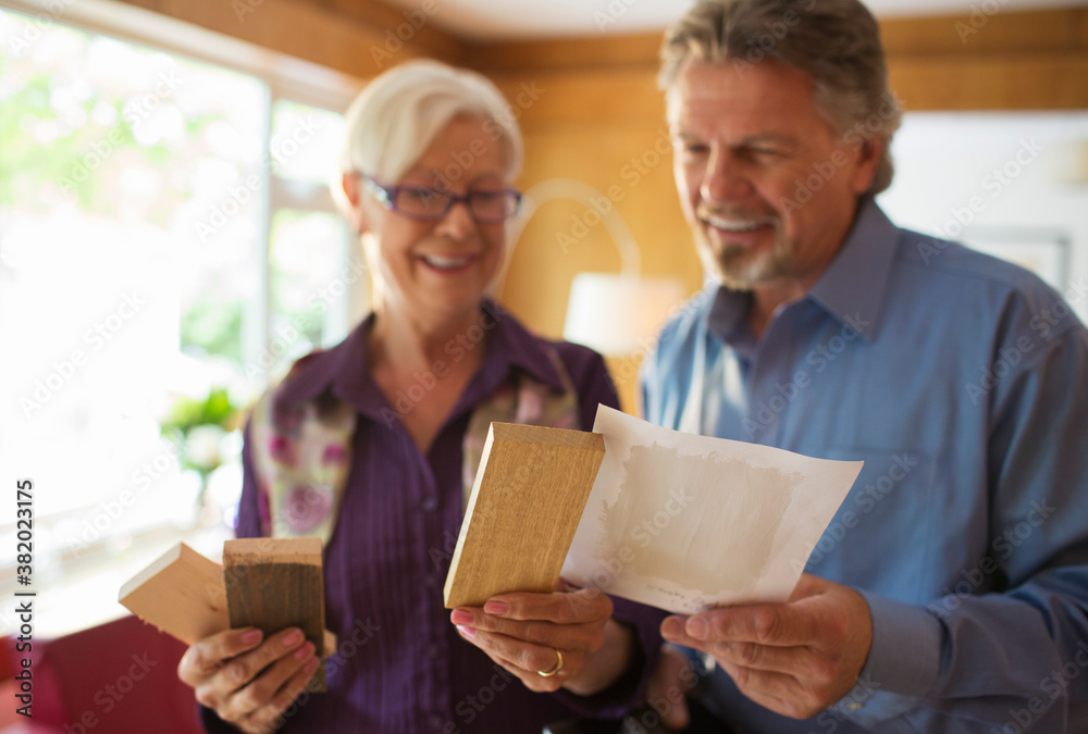Senior couple looking at wood and paint swatches Senior couple looking at wood and paint swatches