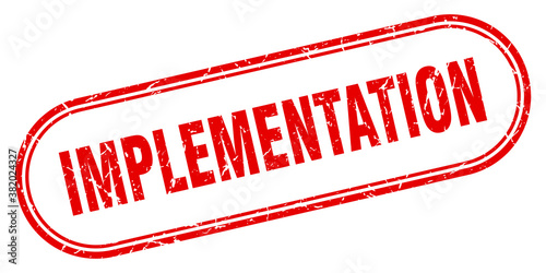 implementation stamp. rounded grunge textured sign. Label