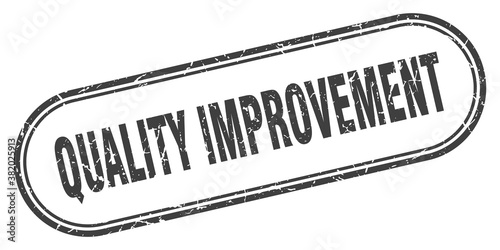 quality improvement stamp. rounded grunge textured sign. Label