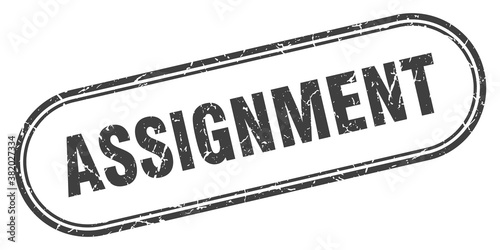 assignment stamp. rounded grunge textured sign. Label