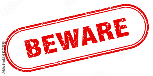 beware stamp. rounded grunge textured sign. Label