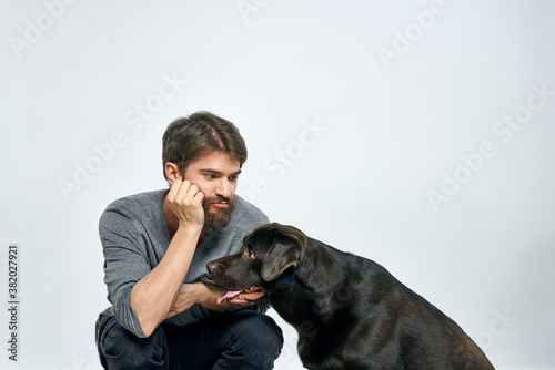 happy owner with pet black dog training model emotions