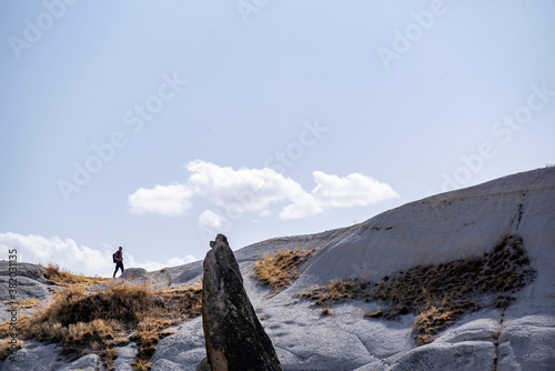 A photographer man standing on the top of the hill and taking shots in Cappadocia, Turkey.
