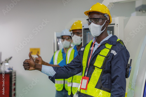 factory worker and team in uniform thumb up together for teamwork