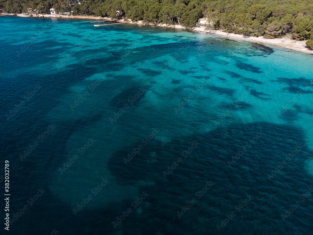 Aerial drone view, beautiful scenic landscape view of mountains and blue crystal clear water on  the shore of Mallorca Island, Balearic Island, Spain