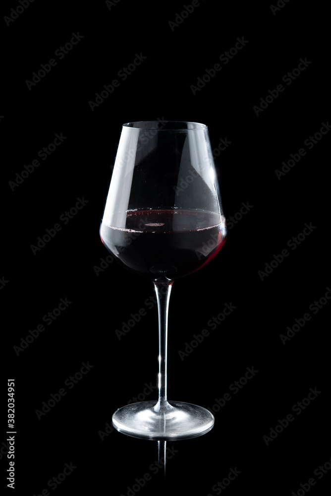 Glass of red wine on the black background Glass of red wine on the black background
