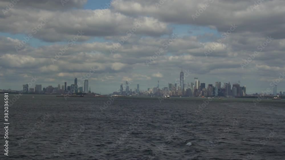 New York Waterfront Skyline, Skyscrapers of Manhattan Under Cloudy Summer Sky. View From Staten Island Ferry
New York Waterfront Skyline, Skyscrapers of Manhattan Under Cloudy Summer Sky. View From Staten Island Ferry