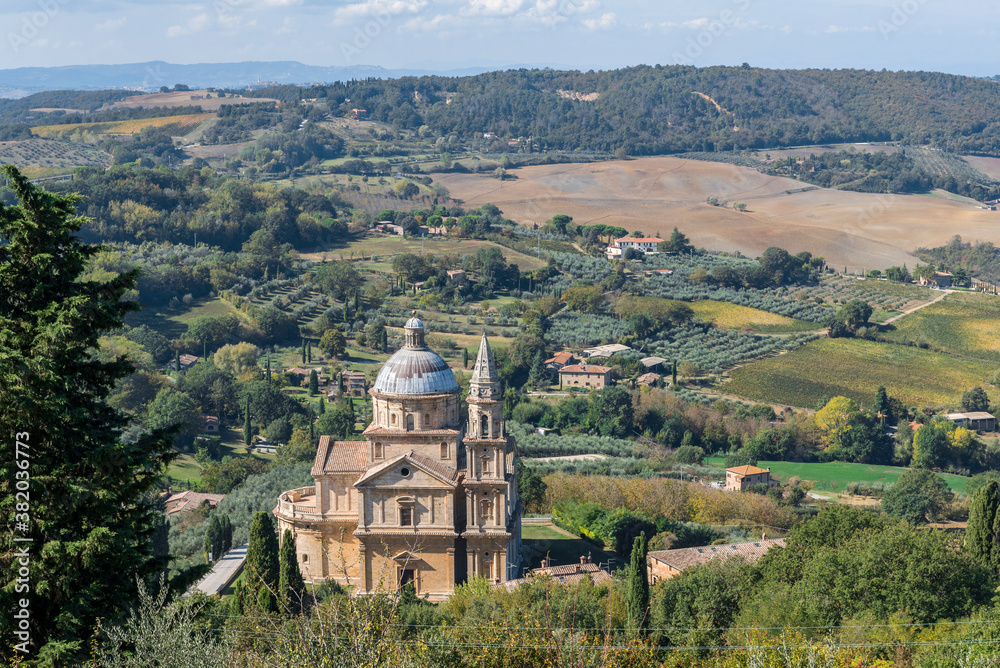 Top view of Church of San Biagio on the outskirts of Montepulciano, Tuscany, Italy, and surroundings of the town with fields, olive groves, vineyards and mountains