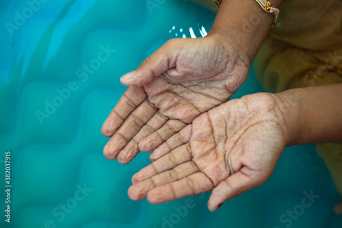 Closeup of children wrinkled wet hands