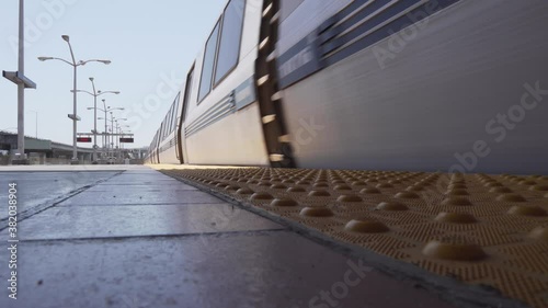 Low Close Up Shot of a Train Car Pulling Up to a Public Transit Transfer Station in a Downtown Busy Area