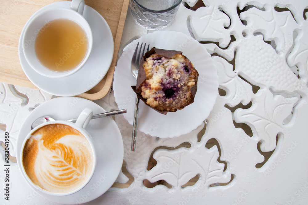 Cup of coffee latte with tea and Muffins. Morning coffee White tone. top view.
