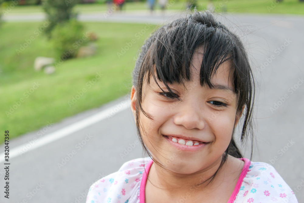 asian young girl with pink bow smiling asian young girl with pink bow smiling