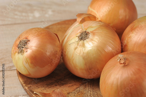 Golden onion on wooden background