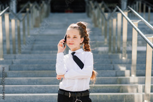 Little school girl having phone talk with friend. modern life communication. Living in digital age. © Ivan Zelenin