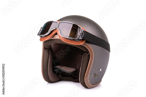 Close up new grey vintage helmet and wind goggle. Studio shot isolated on white
