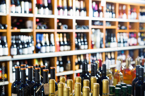 Fotografie Closeup view on various alcohol beverage bottles in wine shop