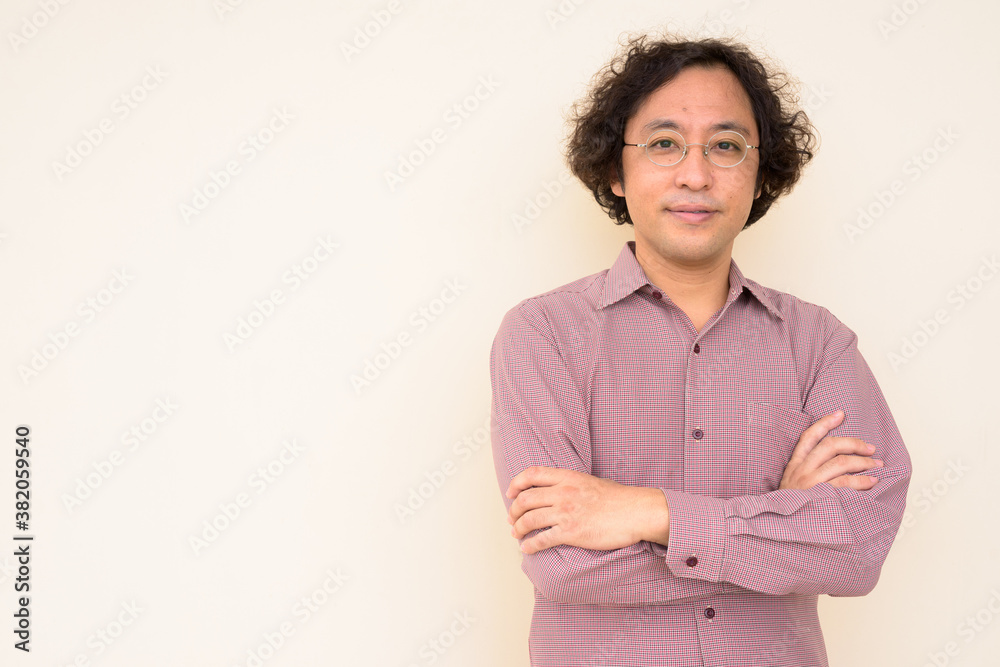 Portrait of Japanese businessman with arms crossed Portrait of Japanese businessman with arms crossed
