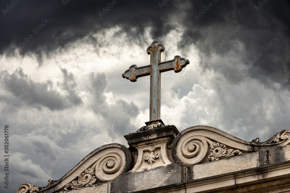 Close-up of an ancient Christian Cross on a dramatic sky, Church of San Daniele (1076-XVII century), Padua, Veneto, Italy, Europe.