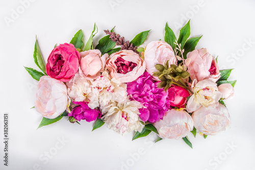 Flat lay of flowers and green leaves