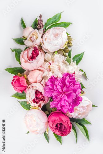 Flat lay of flowers and green leaves