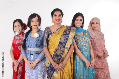 South east Asian Malay Chinese Indian race ethnic origin woman wearing dress costume baju kurung cheongsam samfu kebaya Sharee multiracial community on white background photo