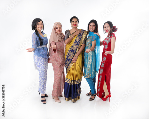 South east Asian Malay Chinese Indian race ethnic origin woman wearing dress costume baju kurung cheongsam samfu kebaya Sharee multiracial community on white background welcome hand gesture photo