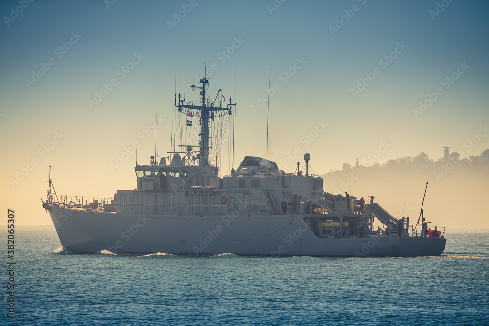 Patrol boat and sea port Varna, Bulgaria. Industrial cranes, ships and boats on the harbour Patrol boat and sea port Varna, Bulgaria. Industrial cranes, ships and boats on the harbour