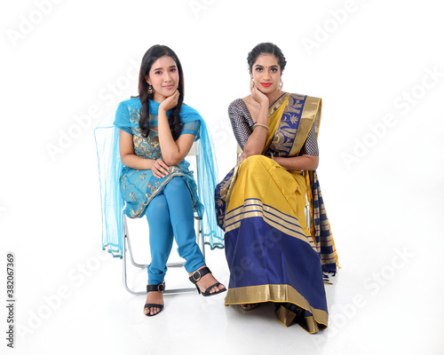 Two South east Asian Indian race ethnic origin woman wearing Indian dress costume sharee and salwar kameez multiracial community on white background photo