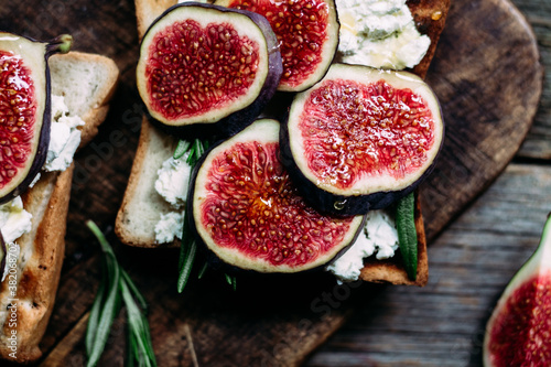 Toast with cream cheese  figs and honey on the table