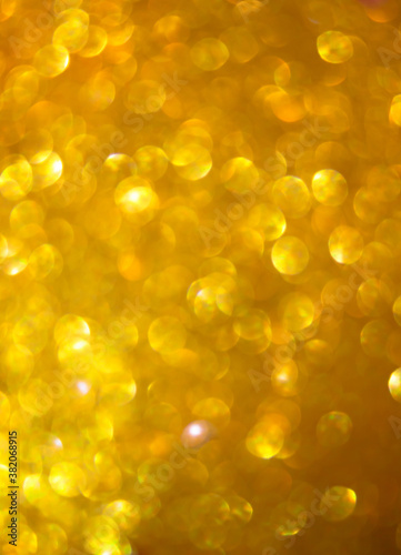 Shiny golden christmas bokeh background for festive design.