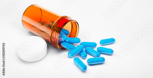 Blue pills with bottle on white background - 3D illustration