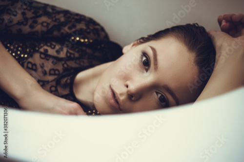 Female high fashion concept. Beautiful fashionable woman posing in bath
