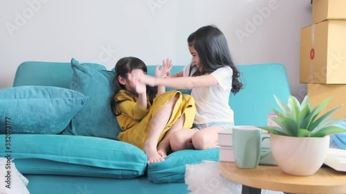 happiness asian child sibling girlfriend playing fun together casual cloth relax leisure weekend activity on sofa couch home