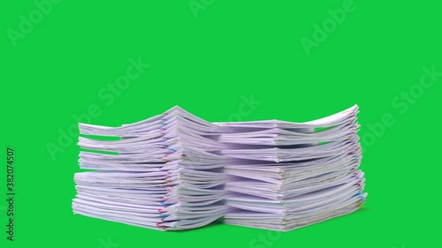 Stop motion animation Stacks overload document paper files on chroma key green screen background. Alpha Channel.