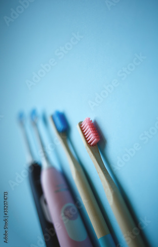 two ultrasonic electric toothbrushes on a blue background