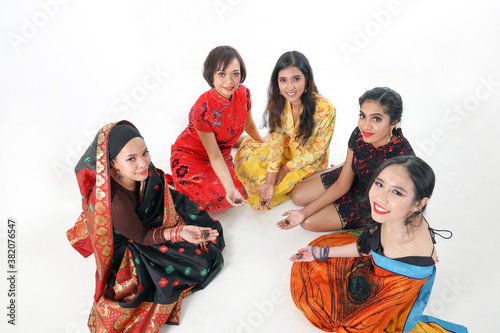South east Asian Malay Chinese Indian race ethnic origin woman wearing dress costume baju kurung cheongsam samfu kebaya Sharee multiracial community playing Batik Batu Seremban on white background
