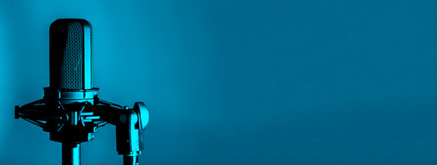 Professional microphone or mic on blue background, recording studio banner
